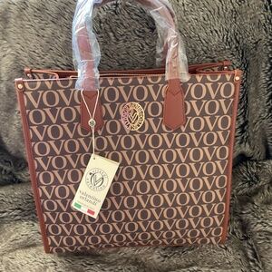 Large Valentino Orlandi bag with insignia all over it.